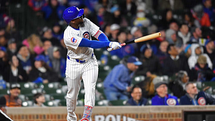 Apr 20, 2024; Chicago, Illinois, USA; Chicago Cubs outfielder Alexander Canario (4) hits a home run during the sixth inning against the Miami Marlins at Wrigley Field. 