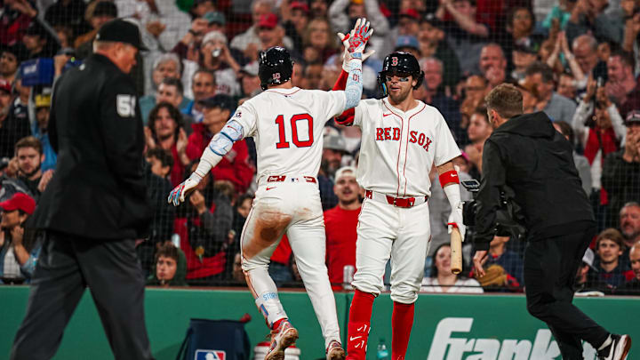 Jun 10, 2025; Boston, Massachusetts, USA; Boston Red Sox shortstop Trevor Story (10) is congratulated by third base Marcelo Mayer (39) after hitting a home run against the Tampa Bay Rays in the sixth inning at Fenway Park. Mandatory Credit: David Butler II-Imagn Images