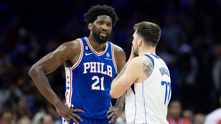Mar 29, 2023; Philadelphia, Pennsylvania, USA; Philadelphia 76ers center Joel Embiid (21) talks with Dallas Mavericks guard Luka Doncic (77) in the final seconds of the game at Wells Fargo Center. Mandatory Credit: Bill Streicher-USA TODAY Sports