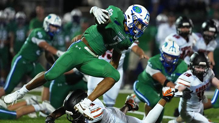 Green Bay Notre Dame's Kingston Allen (7) avoids a tackle during a football game against Kaukauna High School on Aug. 28, 2026, in Green Bay, Wis. Notre Dame defeated Kaukauna 35-28.