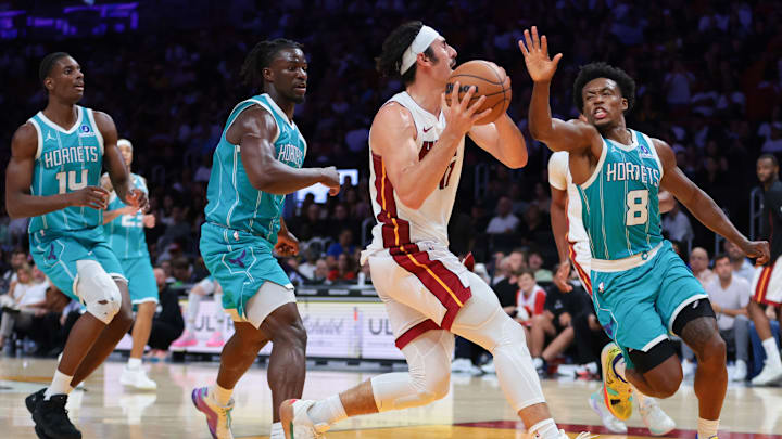 Oct 28, 2025; Miami, Florida, USA; Miami Heat guard Jaime Jaquez Jr. (11) drives to the basket against Charlotte Hornets guard Collin Sexton (8) during the fourth quarter at Kaseya Center. Mandatory Credit: Sam Navarro-Imagn Images