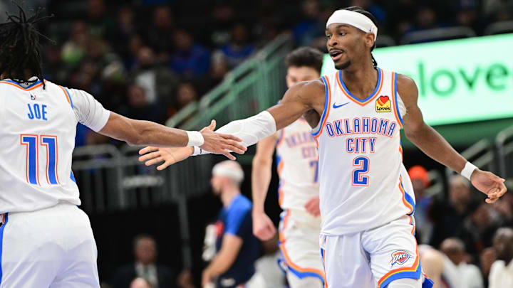Mar 16, 2025; Milwaukee, Wisconsin, USA; Oklahoma City Thunder guard Shai Gilgeous-Alexander (2) celebrates with  guard Isaiah Joe (11) after score in the fourth quarter against the Milwaukee Bucks at Fiserv Forum. Mandatory Credit: Benny Sieu-Imagn Images