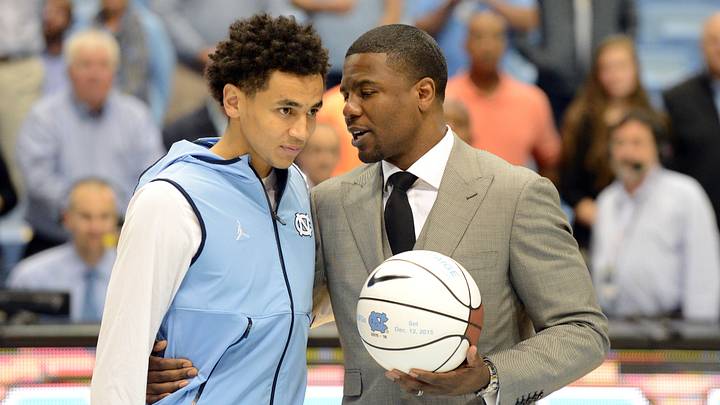 Dec 16, 2015; Chapel Hill, NC, USA; North Carolina Tar Heels guard Marcus Paige (5) receives an award from former player Shammond Williams (right) after setting the record for the most career three pointers prior to a game against the Tulane Green Wave at Dean E. Smith Center. Mandatory Credit: Rob Kinnan-USA TODAY Sports