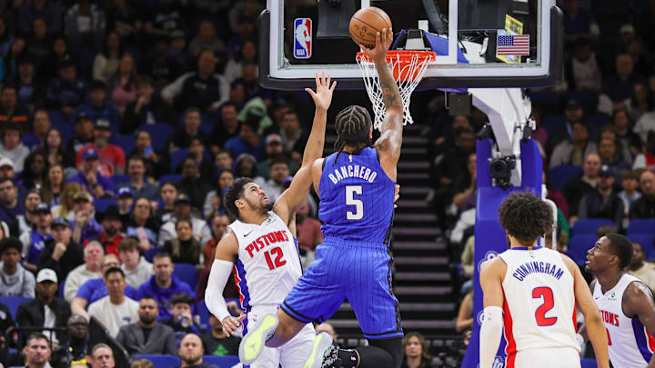 Jan 25, 2025; Orlando, Florida, USA; Orlando Magic forward Paolo Banchero (5) is fouled by Detroit Pistons forward Tobias Harris (12) during the first quarter at Kia Center. Mandatory Credit: Mike Watters-Imagn Images