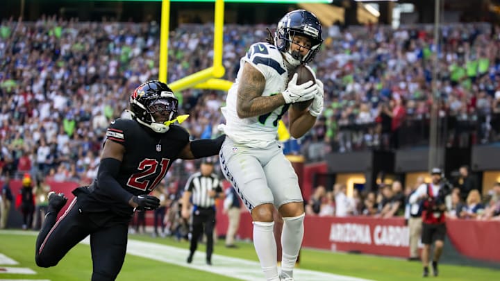 Dec 8, 2024; Glendale, Arizona, USA; Seattle Seahawks wide receiver Jaxon Smith-Njigba (11) catches a touchdown pass against Arizona Cardinals cornerback Garrett Williams (21) in the first half at State Farm Stadium. Mandatory Credit: Mark J. Rebilas-Imagn Images Dec 8, 2024; Glendale, Arizona, USA; Seattle Seahawks wide receiver Jaxon Smith-Njigba (11) catches a touchdown pass against Arizona Cardinals cornerback Garrett Williams (21) in the first half at State Farm Stadium. Mandatory Credit: Mark J. Rebilas-Imagn Images