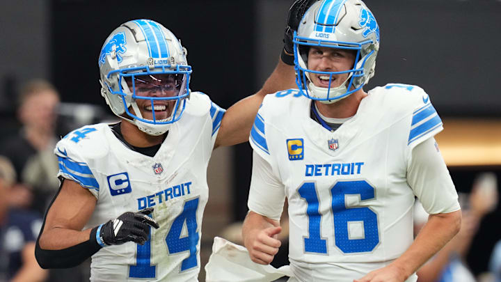 Detroit Lions receiver Amon-Ra St. Brown (14) and quarterback Jared Goff (16) celebrate after completing a hook and ladder play for a touchdown to teammate Jahmyr Gibbs (not pictured) during their game against the Arizona Cardinals at State Farm Stadium in Glendale, Ariz., Sep 22, 2024.