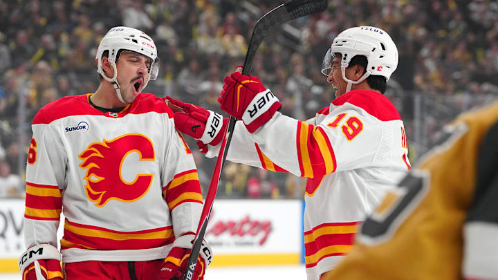 Apr 2, 2026; Las Vegas, Nevada, USA; Calgary Flames center Morgan Frost (16) celebrates with defenseman Zayne Parekh (19) after scoring a goal against the Vegas Golden Knights during the first period at T-Mobile Arena. Mandatory Credit: Stephen R. Sylvanie-Imagn Images Apr 2, 2026; Las Vegas, Nevada, USA; Calgary Flames center Morgan Frost (16) celebrates with defenseman Zayne Parekh (19) after scoring a goal against the Vegas Golden Knights during the first period at T-Mobile Arena. Mandatory Credit: Stephen R. Sylvanie-Imagn Images