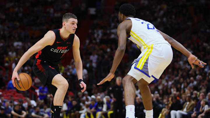 Miami Heat forward Nikola Jovic (5) dribbles the basketball as Golden State Warriors forward Andrew Wiggins (22) defends.
