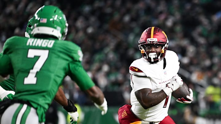 Jan 4, 2026; Philadelphia, Pennsylvania, USA; Washington Commanders wide receiver Deebo Samuel (1) runs after making a catch as Philadelphia Eagles cornerback Kelee Ringo (7) defends during the second quarter at Lincoln Financial Field. Mandatory Credit: Eric Hartline-Imagn Images