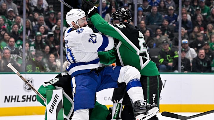 Jan 18, 2026; Dallas, Texas, USA; Dallas Stars defenseman Thomas Harley (55) checks Tampa Bay Lightning left wing Nick Paul (20) in front of goaltender Jake Oettinger (29) during the first period at the American Airlines Center. Mandatory Credit: Jerome Miron-Imagn Images