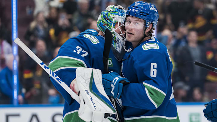 Mar 18, 2025; Vancouver, British Columbia, CAN; Vancouver Canucks goalie Kevin Lankinen (32) and forward Brock Boeser (6) celebrate their victory against the Winnipeg Jets at Rogers Arena. Mandatory Credit: Bob Frid-Imagn Images