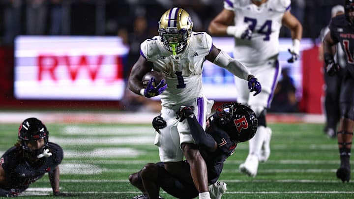 Sep 27, 2024; Piscataway, New Jersey, USA; Washington Huskies running back Jonah Coleman (1) is tackled by Rutgers Scarlet Knights defensive back Robert Longerbeam (7) during the first half at SHI Stadium. Mandatory Credit: Vincent Carchietta-Imagn Images