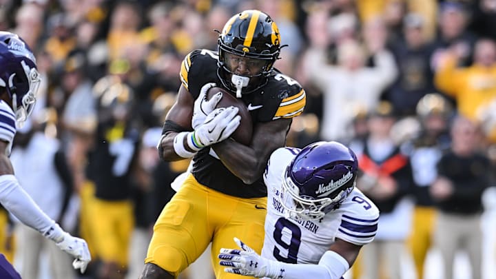 Oct 26, 2024; Iowa City, Iowa, USA; Iowa Hawkeyes running back Kaleb Johnson (2) runs for a 26 yard touchdown against Northwestern Wildcats defensive back Braden Turner (9) during the second quarter at Kinnick Stadium. Oct 26, 2024; Iowa City, Iowa, USA; Iowa Hawkeyes running back Kaleb Johnson (2) runs for a 26 yard touchdown against Northwestern Wildcats defensive back Braden Turner (9) during the second quarter at Kinnick Stadium.