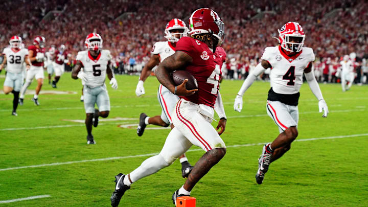 Sep 28, 2024; Tuscaloosa, Alabama, USA; Alabama Crimson Tide quarterback Jalen Milroe (4) scores a touchdown during the second quarter against the Georgia Bulldogs at Bryant-Denny Stadium. Mandatory Credit: John David Mercer-Imagn Images Sep 28, 2024; Tuscaloosa, Alabama, USA; Alabama Crimson Tide quarterback Jalen Milroe (4) scores a touchdown during the second quarter against the Georgia Bulldogs at Bryant-Denny Stadium. Mandatory Credit: John David Mercer-Imagn Images