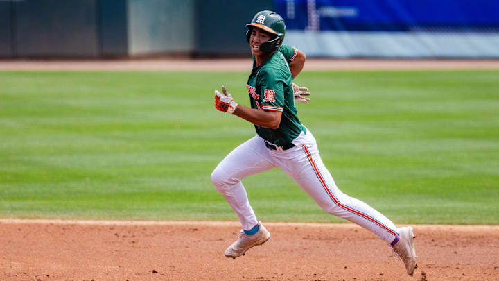 May 23, 2024; Charlotte, NC, USA; Miami (Fl) Hurricanes infielder Daniel Cuvet (14) heads to third against the Clemson Tigers in the second inning during the ACC Baseball Tournament at Truist Field. Mandatory Credit: Scott Kinser-Imagn Images