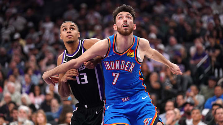 Mar 25, 2025; Sacramento, California, USA; Oklahoma City Thunder center Chet Holmgren (7) battles for position with Sacramento Kings forward Keegan Murray (13) in the first quarter at the Golden 1 Center. Mandatory Credit: Cary Edmondson-Imagn Images