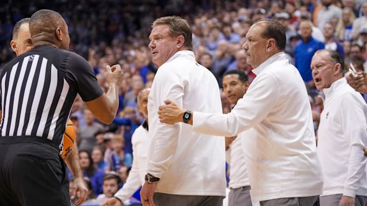Feb 6, 2023; Lawrence, Kansas, USA; Kansas Jayhawks assistant coach Kurt Townsend restrains head coach Bill Self against the Texas Longhorns during the second half at Allen Fieldhouse. Mandatory Credit: Denny Medley-Imagn Images