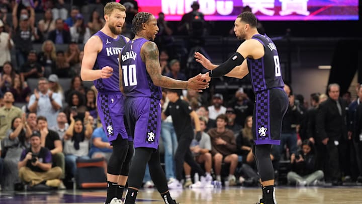 Apr 11, 2025; Sacramento, California, USA; Sacramento Kings forward DeMar DeRozan (10) talks with forward Domantas Sabonis (left) and guard Zach LaVine (8) during the fourth quarter against the Los Angeles Clippers at Golden 1 Center. Mandatory Credit: Darren Yamashita-Imagn Images
