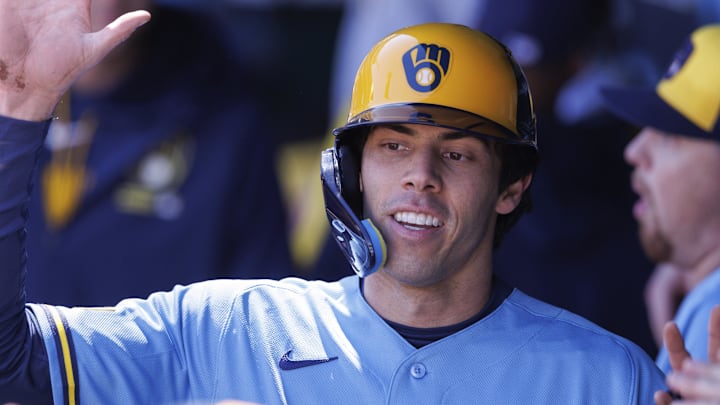 Apr 4, 2026; Kansas City, Missouri, USA; Milwaukee Brewers left fielder Christian Yelich (22) celebrates in the dugout after scoring during the first inning against the Kansas City Royals at Kauffman Stadium. Mandatory Credit: William Purnell-Imagn Images