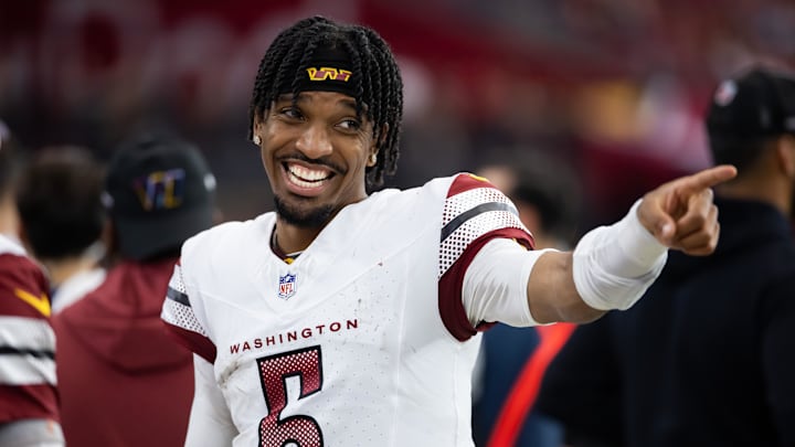 Sep 29, 2024; Glendale, Arizona, USA; Washington Commanders quarterback Jayden Daniels (5) celebrates in the closing seconds of the game against the Arizona Cardinals at State Farm Stadium. Mandatory Credit: Mark J. Rebilas-Imagn Images Sep 29, 2024; Glendale, Arizona, USA; Washington Commanders quarterback Jayden Daniels (5) celebrates in the closing seconds of the game against the Arizona Cardinals at State Farm Stadium. Mandatory Credit: Mark J. Rebilas-Imagn Images
