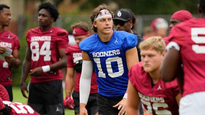 Quarterback John Mateer leads Oklahoma through a walkthrough before a fall camp practice. Quarterback John Mateer leads Oklahoma through a walkthrough before a fall camp practice.