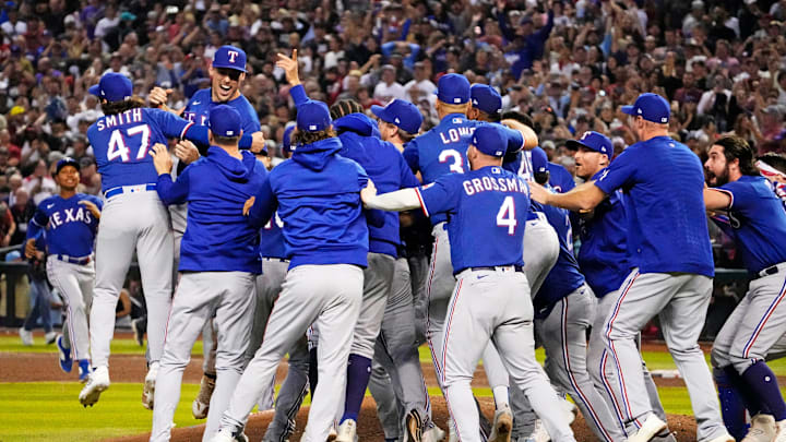 The Texas Rangers celebrate after beating the Arizona Diamondbacks to win the World Series in game