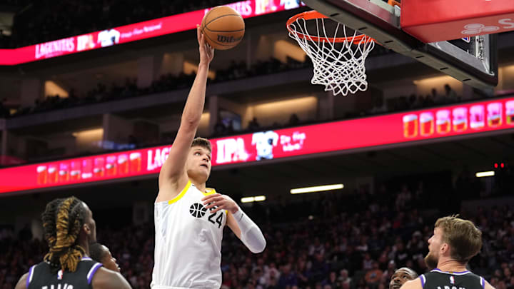 Mar 31, 2024; Sacramento, California, USA; Utah Jazz center Walker Kessler (24) shoots against Sacramento Kings guard Keon Ellis (left) and forward Domantas Sabonis (right) during the third quarter at Golden 1 Center. Mandatory Credit: Darren Yamashita-USA TODAY Sports