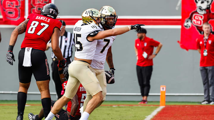 Oct 5, 2024; Raleigh, North Carolina, USA; Wake Forest Demon Deacons defensive back Evan Slocum (7) and Wake Forest Demon Deacons defensive back Devin Cook (15) celebrate a touchdown during the first half of the game against North Carolina State Wolfpack at Carter-Finley Stadium. Mandatory Credit: Jaylynn Nash-Imagn Images