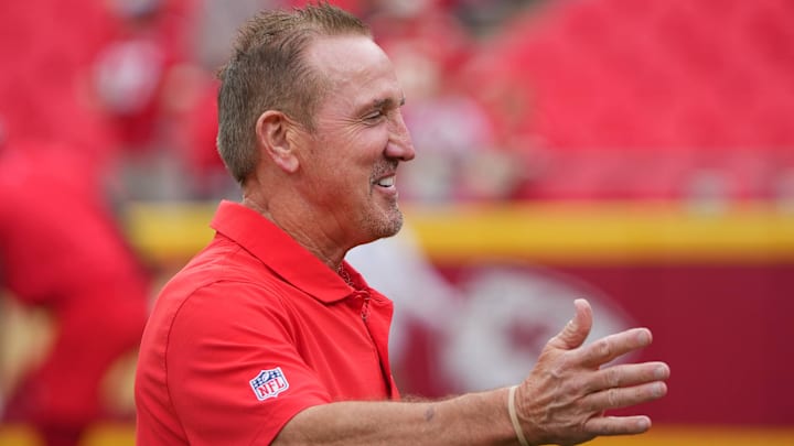 Aug 22, 2024; Kansas City, Missouri, USA; Kansas City Chiefs defensive coordinator Steve Spagnuolo greets a friend on field during warm ups against the Chicago Bears prior to a game at GEHA Field at Arrowhead Stadium. Mandatory Credit: Denny Medley-Imagn Images