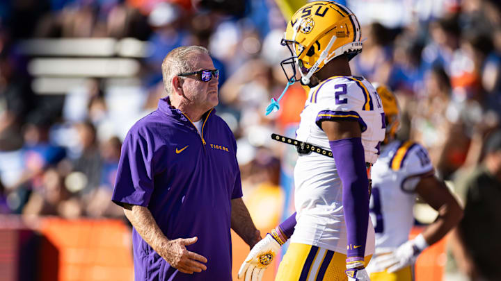 Nov 16, 2024; Gainesville, Florida, USA; LSU Tigers head coach Brian Kelly talks with LSU Tigers wide receiver Kyren Lacy (2) before a game against the Florida Gators at Ben Hill Griffin Stadium. Mandatory Credit: Matt Pendleton-Imagn Images