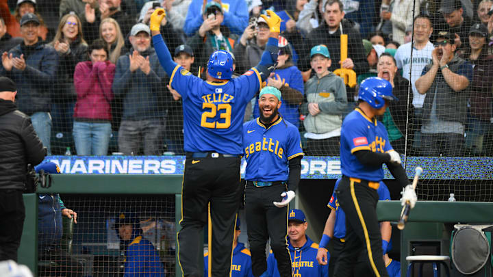 Seattle Mariners shortstop J.P. Crawford (center) celebrates with first baseman Rowdy Tellez (23) after Tellez hit a home run against the Texas Rangers on April 11 at T-Mobile Park. Seattle Mariners shortstop J.P. Crawford (center) celebrates with first baseman Rowdy Tellez (23) after Tellez hit a home run against the Texas Rangers on April 11 at T-Mobile Park.