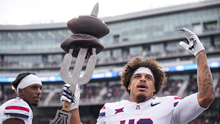 Nov 15, 2025; Cincinnati, Ohio, USA;  Arizona Wildcats defensive back Dalton Johnson (43) celebrates on the sidelines after intercepting a pass against the Cincinnati Bearcats in the first half at Nippert Stadium. Mandatory Credit: Aaron Doster-Imagn Images