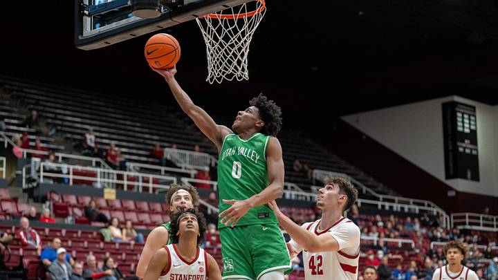 Dec 3, 2024; Stanford, California, USA; Utah Valley Wolverines guard Dominick Nelson (0) shoots a layup against Stanford Cardinal forward Maxime Raynaud (42) during the second half at Maples Pavilion. Mandatory Credit: Neville E. Guard-Imagn Images Dec 3, 2024; Stanford, California, USA; Utah Valley Wolverines guard Dominick Nelson (0) shoots a layup against Stanford Cardinal forward Maxime Raynaud (42) during the second half at Maples Pavilion. Mandatory Credit: Neville E. Guard-Imagn Images
