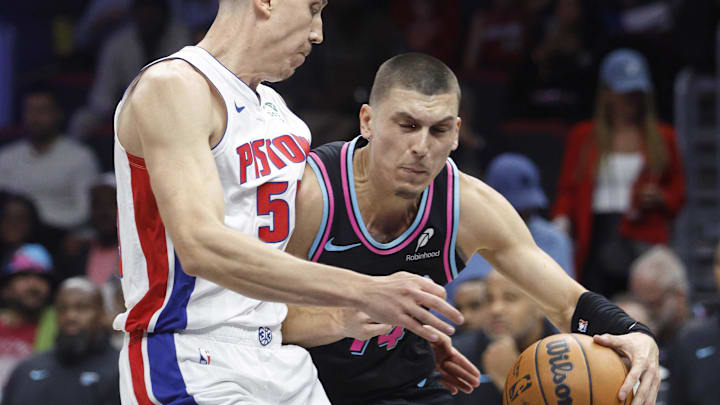 Nov 29, 2025; Miami, Florida, USA; Miami Heat guard Tyler Herro (14) drives with the ball against Detroit Pistons forward Duncan Robinson (55) during the first half at Kaseya Center. Mandatory Credit: Rhona Wise-Imagn Images