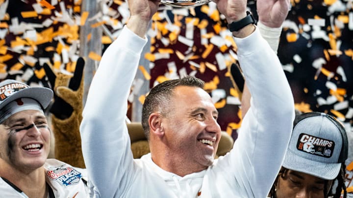 Texas Longhorns head coach Steve Sarkisian raises the trophy as the Texas Longhorns celebrate their 39-31 double overtime win over the Arizona State Sun Devils in the Peach Bowl College Football Playoff quarterfinal at Mercedes-Benz Stadium in Atlanta, Georgia, Jan. 1, 2025.