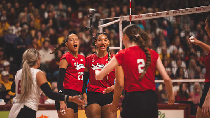 Nebraska volleyball players celebrate a point at Minnesota.