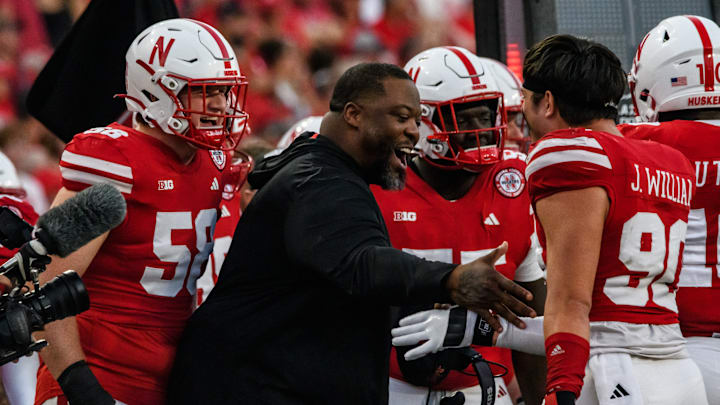 James Williams celebrates the Nebraska defense's final stop of the game with defensive line  coach Terrance Knighton.   