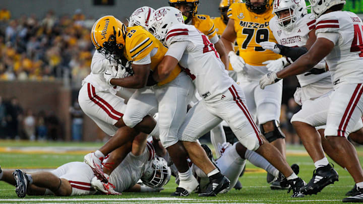 Sept 27, 2025; Columbia, Missouri, USA; Missouri Tigers running back Ahmad Hardy continues to rush while being held and chased by multiple UMass defenders. Sept 27, 2025; Columbia, Missouri, USA; Missouri Tigers running back Ahmad Hardy continues to rush while being held and chased by multiple UMass defenders.