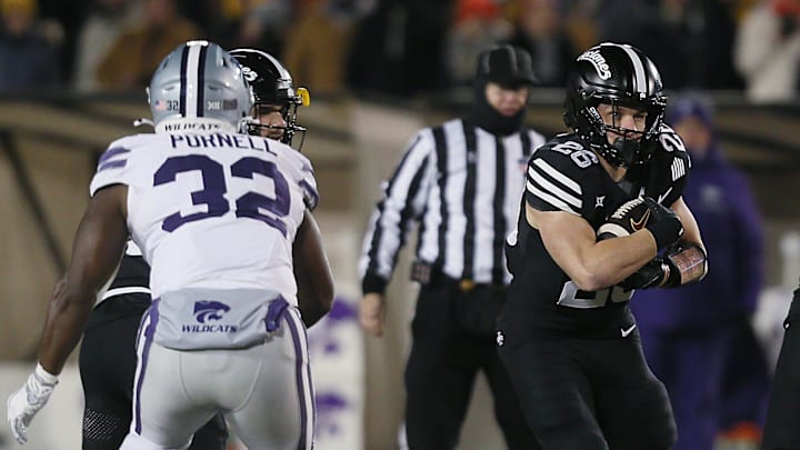 Iowa State Cyclones running back Carson Hansen (26) runs with the ball around Kansas State Wildcats linebacker Desmond Purnell (32) during the first quarter in the NCAA football at Jack Trice Stadium on Saturday, Nov. 30, 2024, in Ames, Iowa.