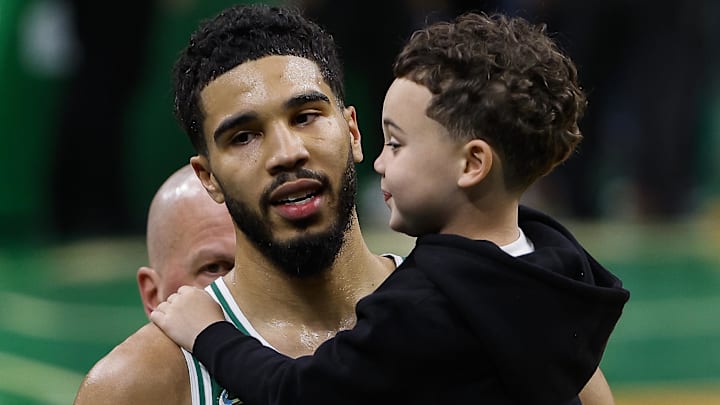 Boston Celtics forward Jayson Tatum (0) carries his son, Jason Jr. off the court following their win over the Brooklyn Nets in game two of the first round of the 2022 NBA playoffs at TD Garden.