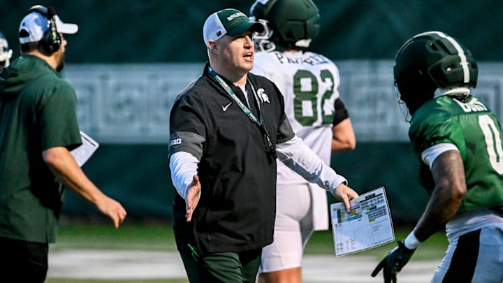 Michigan State's head coach Pat Fitzgerald, left, slaps hands with NiJhay Burt during spring football practice on Tuesday, April 14, 2026, in East Lansing. Michigan State's head coach Pat Fitzgerald, left, slaps hands with NiJhay Burt during spring football practice on Tuesday, April 14, 2026, in East Lansing.