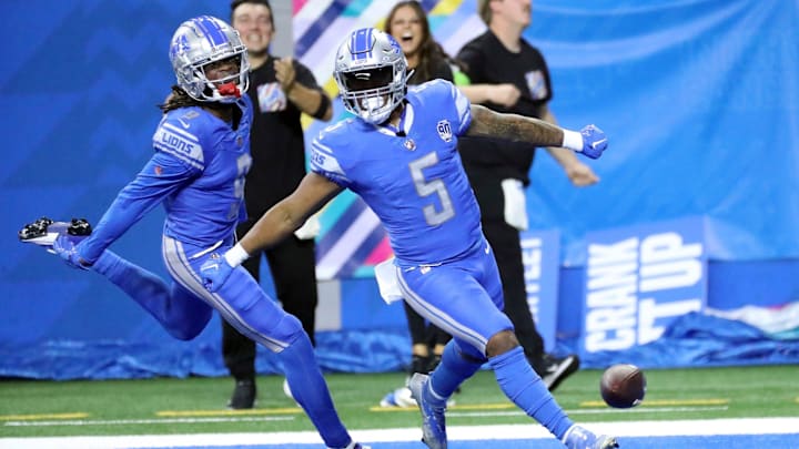 Lions receiver Jameson Williams celebrates with running back David Montgomery.