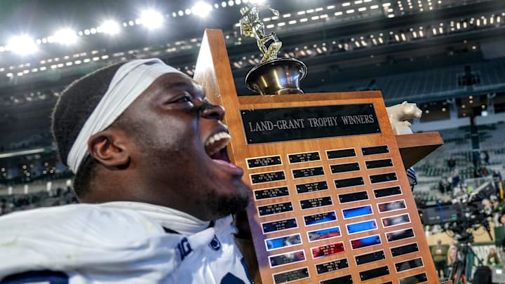 Penn State Nittany Lions lineman Anthony Donkoh carries the Land Grant Trophy after a win over the Michigan State Spartans. 