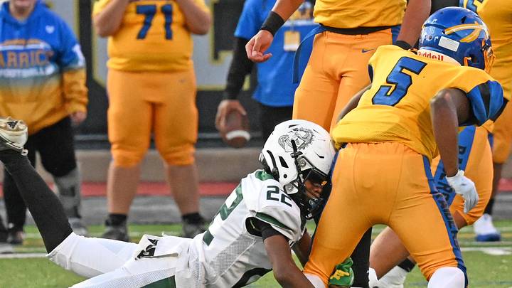 Allderdice's Josh Eberhardt helps wrap up Carrick running back Paris Henderson Thursday at Cupples Stadium in Pitsburgh. Allderdice's Josh Eberhardt helps wrap up Carrick running back Paris Henderson Thursday at Cupples Stadium in Pitsburgh.