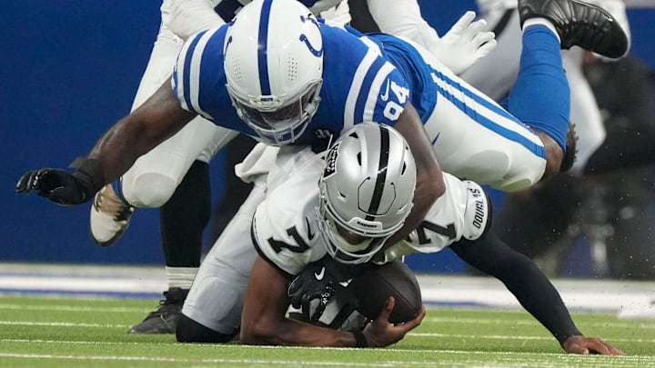 Indianapolis Colts defensive end Tyquan Lewis (94) brings down Las Vegas Raiders quarterback Geno Smith (7) on Sunday, Oct. 5, 2025, during a game at Lucas Oil Stadium in Indianapolis. The Colts defeated the Raiders 40-6.