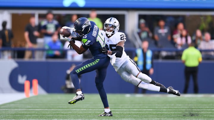Aug 7, 2025; Seattle, Washington, USA; Seattle Seahawks wide receiver Tory Horton (15) catches a pass while covered by Las Vegas Raiders cornerback Decamerion Richardson (25) during the first half at Lumen Field. 