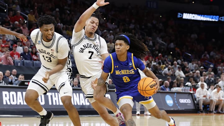 Mar 19, 2026; Oklahoma City, OK, USA; McNeese Cowboys guard Tyshawn Archie (8) drives to the hoop past Vanderbilt Commodores guard Chandler Bing (7) and forward Jalen Washington (13) during the second half during a first round game of the men's 2026 NCAA Tournament at Paycom Center. Mandatory Credit: Alonzo Adams-Imagn Images