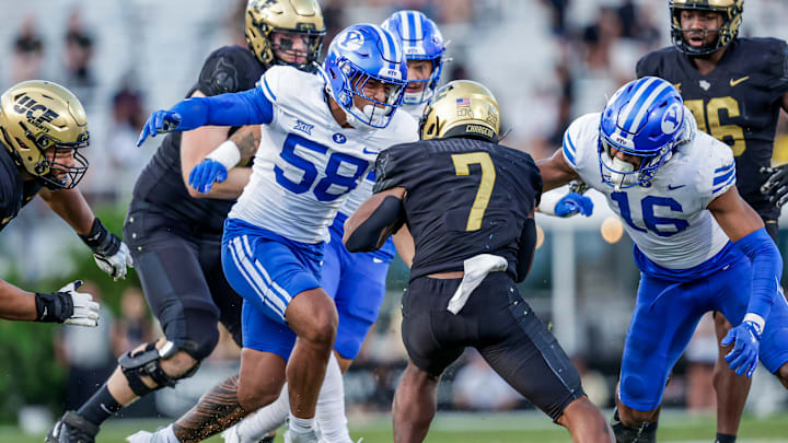 BYU linebackers Isaiah Glasker and Aisea Moa make a tackle against UCF