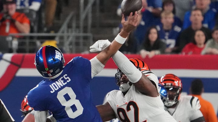 Oct 13, 2024; East Rutherford, New Jersey, USA;  Cincinnati Bengals defensive tackle B.J. Hill (92) forces an interception on a throw by New York Giants quarterback Daniel Jones (8) during the first quarter at MetLife Stadium. Mandatory Credit: Robert Deutsch-Imagn Images