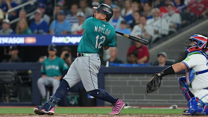 Oct 19, 2025; Toronto, Ontario, CAN; Seattle Mariners first baseman Josh Naylor (12) singles in the fourth inning against the Toronto Blue Jays during game six of the ALCS round for the 2025 MLB playoffs at Rogers Centre. Mandatory Credit: Nick Turchiaro-Imagn Images Oct 19, 2025; Toronto, Ontario, CAN; Seattle Mariners first baseman Josh Naylor (12) singles in the fourth inning against the Toronto Blue Jays during game six of the ALCS round for the 2025 MLB playoffs at Rogers Centre. Mandatory Credit: Nick Turchiaro-Imagn Images